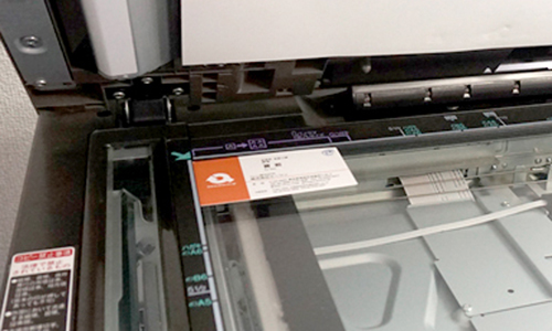 シャープカラー複合機（コピー機）MX-2640FNのガラス原稿台にカードをセットしている様子